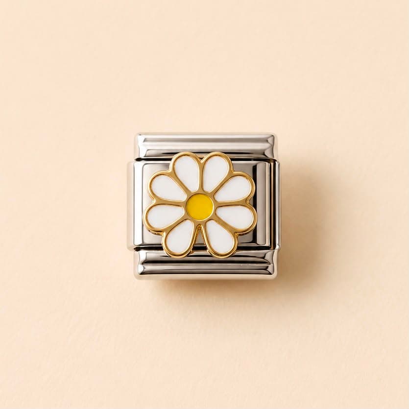 A square silver-toned charm link featuring a white daisy flower with gold trim and a yellow center, set against a solid beige background.
