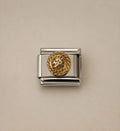 A silver-toned Italian charm link featuring a circular gold-toned lion head medallion, shown on a plain beige background.