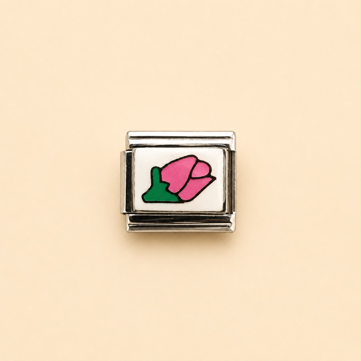 A silver-toned rectangular charm link featuring a white face with a pink tulip flower and green leaf design, centered on a solid pale beige background.