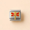 A rectangular Italian charm link with a polished silver-tone metal body and a central gold-tone dragonfly motif with red enamel wings, set against a solid pale peach background.