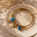 Inspired by the sea, this charm bracelet features turquoise accents and delicate ocean-inspired charms on a premium 18K gold-plated stainless steel base. Waterproof, anti-tarnish, and skin-friendly, it's the perfect everyday accessory for effortless coastal elegance.
