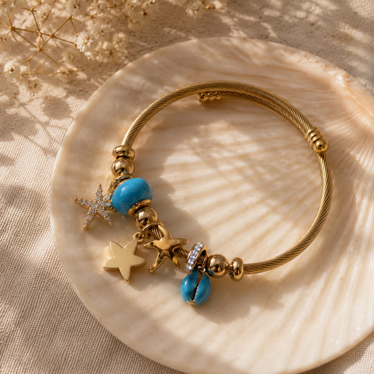 Inspired by the sea, this charm bracelet features turquoise accents and delicate ocean-inspired charms on a premium 18K gold-plated stainless steel base. Waterproof, anti-tarnish, and skin-friendly, it's the perfect everyday accessory for effortless coastal elegance.