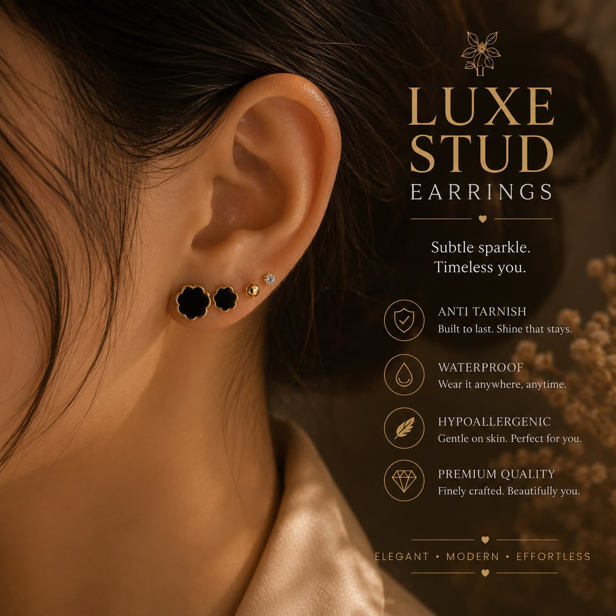 Close-up of a woman's ear wearing black flower-shaped stud earrings and a small gold stud, with marketing text for Luxe Stud Earrings on the right side.